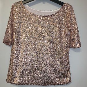Loose fit boat neck or off shoulder sequin top. Fully lined